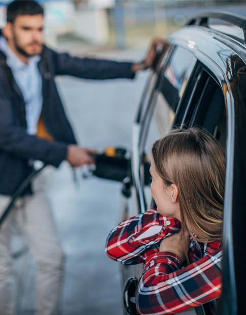 Couple at gas station - Agero Extended Benefits