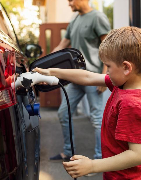 EV Experience son and Dad charging vehicle