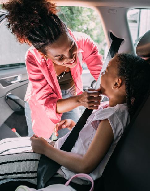 Agero - Mom assisting Daughter with seatbelt.